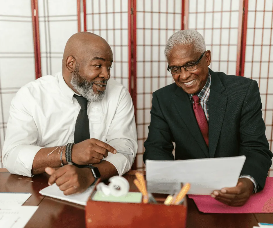 Two business owners reviewing marketing documents together